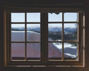 An image of an old window showing snow outside